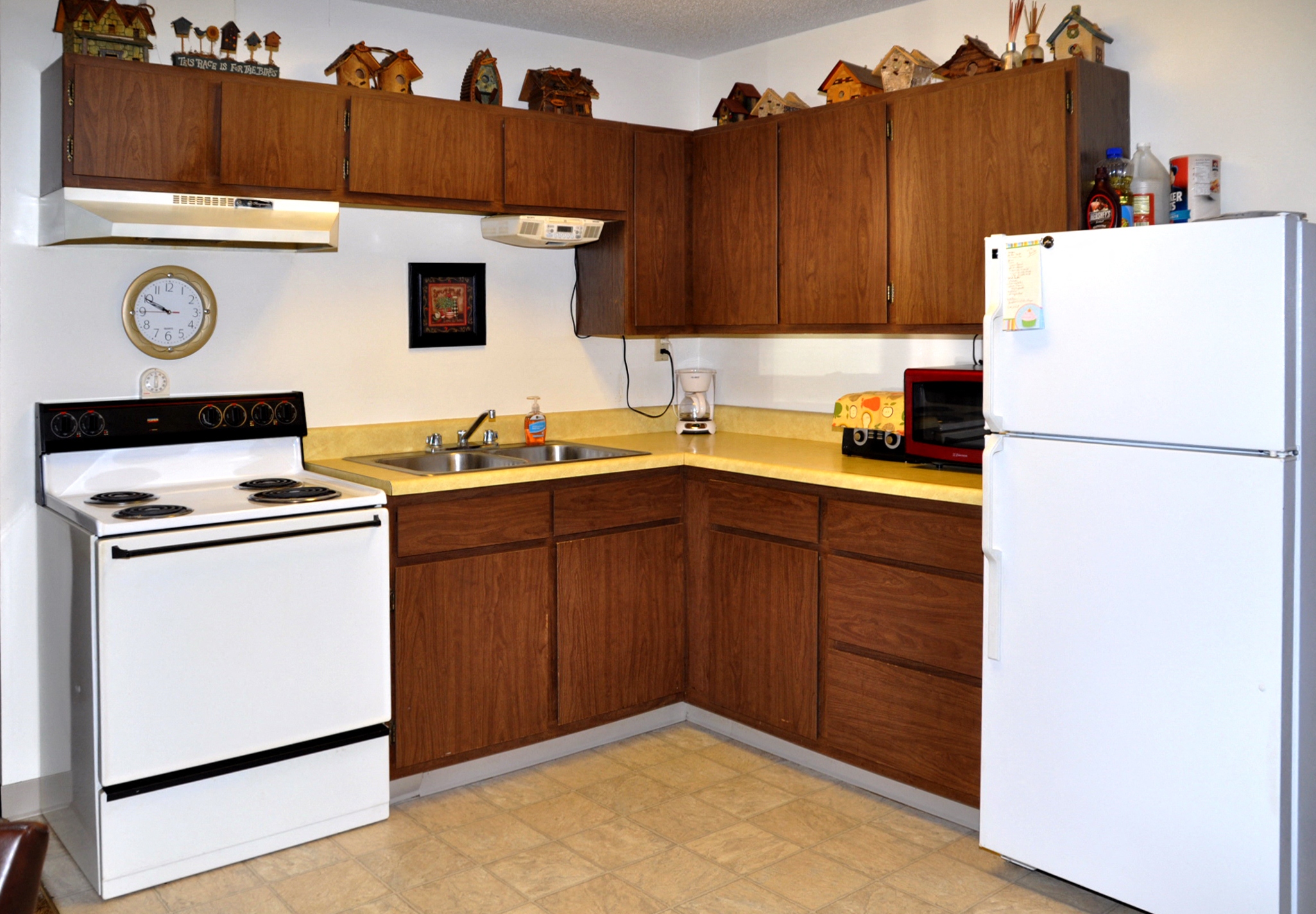 a kitchen with white appliances and wooden cabinets